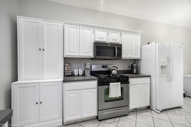 20739 N Weiland Rd, Prairie View, IL 60069 - kitchen with stainless steel gas range, white fridge with ice dispenser, dark countertops, white cabinets, and light tile patterned floors