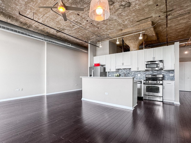 1550 S Blue Island Ave Unit 1125, Chicago, IL 60608 - kitchen featuring stainless steel appliances, tasteful backsplash, white cabinets, and dark wood-style floors