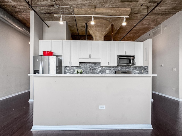 1550 S Blue Island Ave Unit 1125, Chicago, IL 60608 - kitchen with stainless steel appliances, rail lighting, dark wood-type flooring, and white cabinetry
