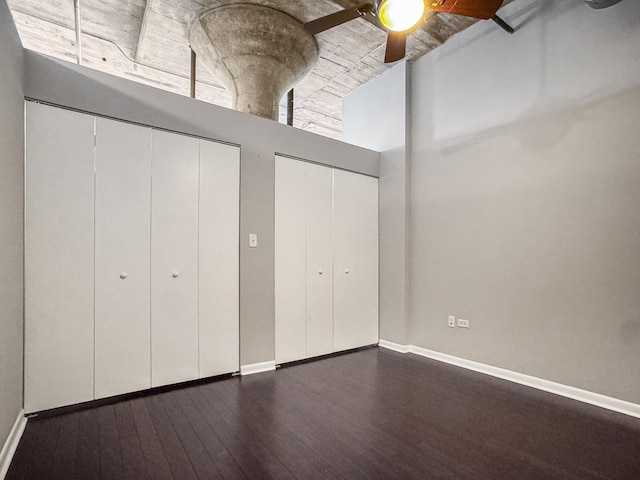 1550 S Blue Island Ave Unit 1125, Chicago, IL 60608 - unfurnished bedroom featuring multiple closets, dark wood-style floors, a high ceiling, and ceiling fan