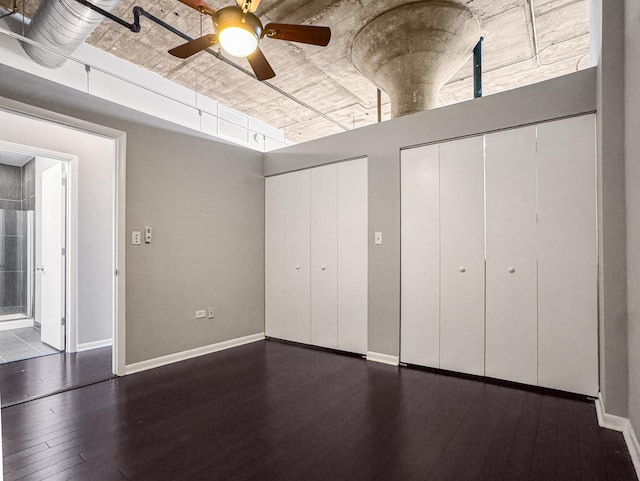 1550 S Blue Island Ave Unit 1125, Chicago, IL 60608 - unfurnished bedroom with multiple closets, dark wood finished floors, and a ceiling fan
