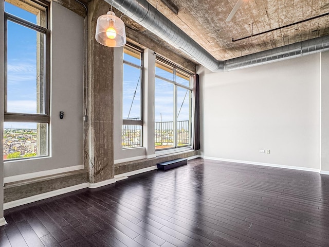 1550 S Blue Island Ave Unit 1125, Chicago, IL 60608 - spare room with dark wood-type flooring and baseboards