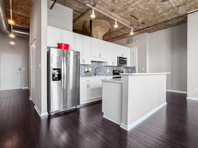 1550 S Blue Island Ave Unit 1125, Chicago, IL 60608 - kitchen with appliances with stainless steel finishes, rail lighting, dark wood-style flooring, and light countertops