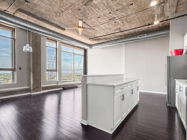 1550 S Blue Island Ave Unit 1125, Chicago, IL 60608 - kitchen with freestanding refrigerator, dark wood-type flooring, ceiling fan, white cabinetry, and light countertops