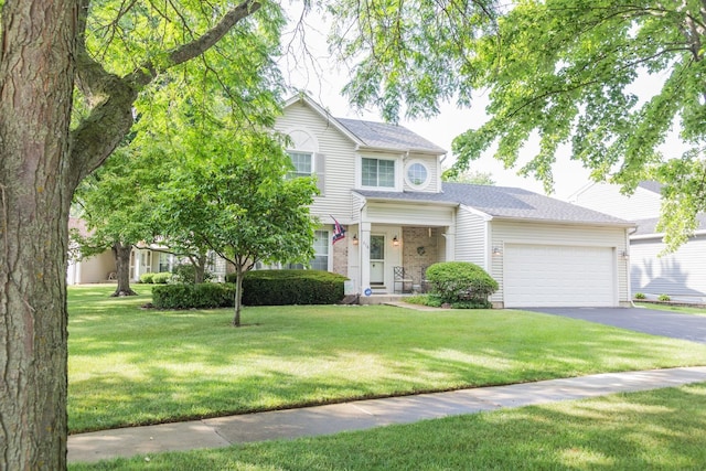 216 Dickens Trl, Elgin, IL 60120 - view of front of home with an attached garage, asphalt driveway, and a front yard