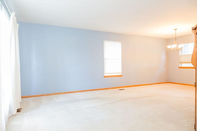 216 Dickens Trl, Elgin, IL 60120 - carpeted empty room with a chandelier and baseboards