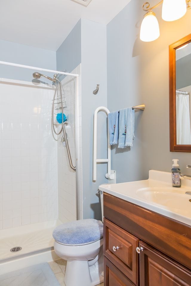 216 Dickens Trl, Elgin, IL 60120 - full bathroom featuring vanity, tiled shower, and tile patterned floors