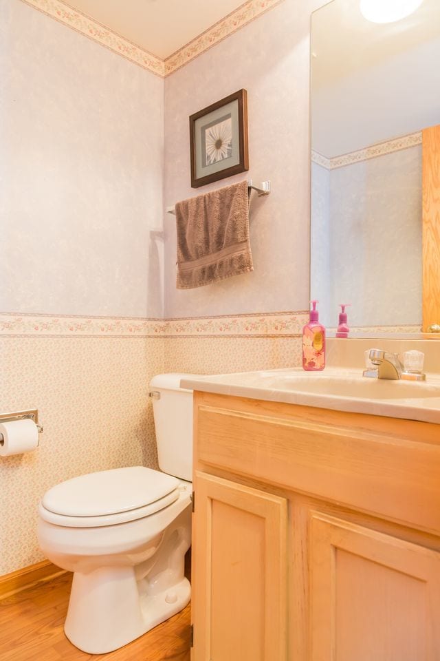216 Dickens Trl, Elgin, IL 60120 - half bath with wallpapered walls, vanity, and wood finished floors