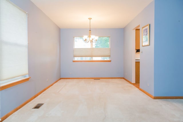 216 Dickens Trl, Elgin, IL 60120 - spare room featuring a chandelier and carpet flooring