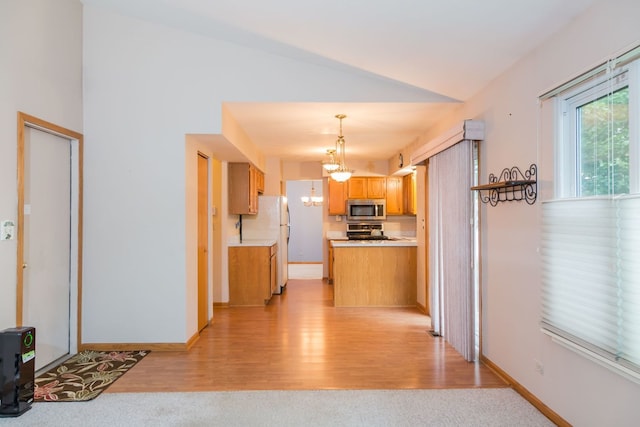 216 Dickens Trl, Elgin, IL 60120 - kitchen featuring stainless steel microwave, range, light wood-style flooring, freestanding refrigerator, and vaulted ceiling