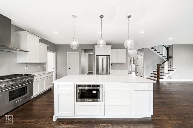 1122 W Wilson St, Palatine, IL 60067 - kitchen featuring stainless steel appliances, wall chimney exhaust hood, light countertops, white cabinets, and recessed lighting