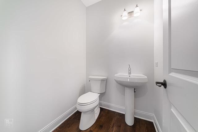 1122 W Wilson St, Palatine, IL 60067 - half bath featuring toilet and wood finished floors