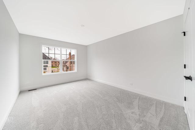 1122 W Wilson St, Palatine, IL 60067 - carpeted spare room featuring baseboards