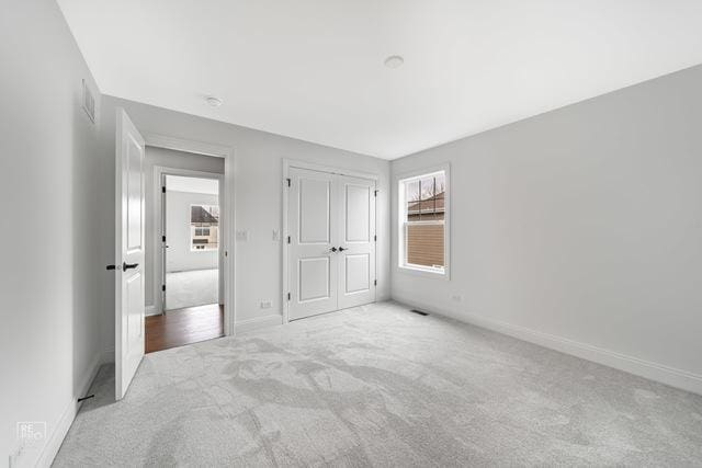 1122 W Wilson St, Palatine, IL 60067 - unfurnished bedroom featuring carpet flooring and a closet