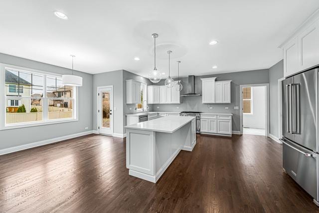 1122 W Wilson St, Palatine, IL 60067 - kitchen featuring appliances with stainless steel finishes, wall chimney range hood, light countertops, dark wood finished floors, and recessed lighting