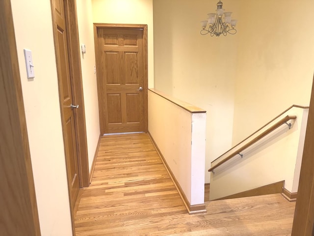 1136 Park Pl, Bellwood, IL 60104 - hall with an upstairs landing, light wood-style flooring, and a chandelier