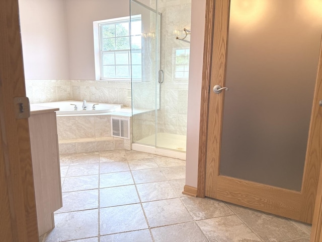1136 Park Pl, Bellwood, IL 60104 - bathroom featuring a garden tub, a shower stall, and tile patterned flooring