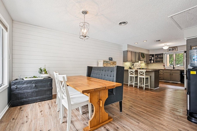 412 E S St, Peotone, IL 60468 - dining space with a textured ceiling, wood finished floors, and wood walls