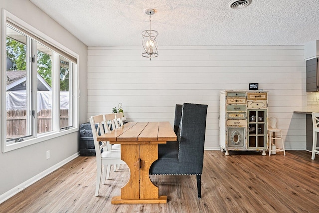 412 E S St, Peotone, IL 60468 - dining space with a textured ceiling, wood finished floors, and wooden walls