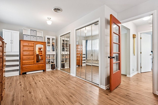 412 E S St, Peotone, IL 60468 - entryway featuring light wood finished floors, a baseboard radiator, and french doors