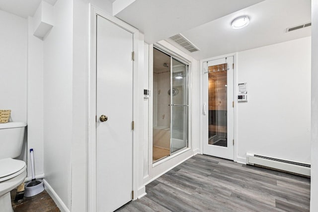412 E S St, Peotone, IL 60468 - bathroom featuring a baseboard heating unit, wood finished floors, and a shower stall