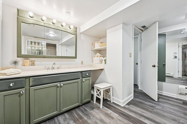 412 E S St, Peotone, IL 60468 - bathroom with wood finished floors, vanity, and baseboard heating