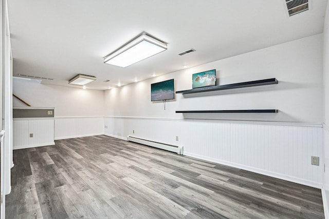 412 E S St, Peotone, IL 60468 - basement with a baseboard radiator, a wainscoted wall, and wood finished floors