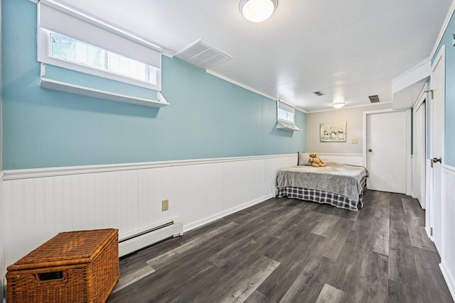 412 E S St, Peotone, IL 60468 - bedroom with a baseboard heating unit, wainscoting, and dark wood-style flooring