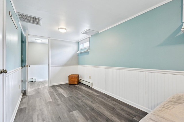 412 E S St, Peotone, IL 60468 - spare room featuring a baseboard radiator, baseboard heating, wood finished floors, and wainscoting