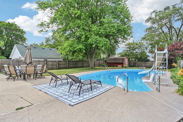 412 E S St, Peotone, IL 60468 - view of swimming pool featuring a water slide, a fenced backyard, a patio, and a shed