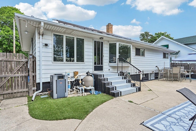 412 E S St, Peotone, IL 60468 - back of house featuring a chimney, outdoor dining space, a patio area, and entry steps