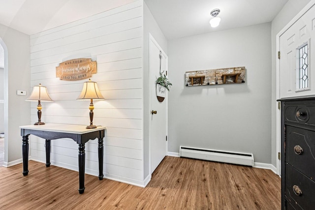 412 E S St, Peotone, IL 60468 - doorway featuring a baseboard heating unit, wood finished floors, and arched walkways