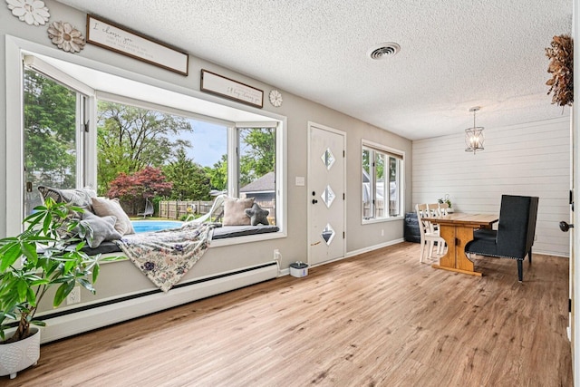 412 E S St, Peotone, IL 60468 - foyer featuring baseboard heating, wood finished floors, and a textured ceiling