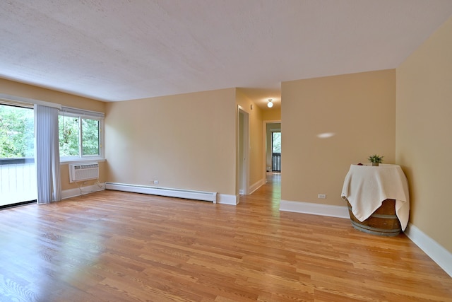1813 Hemlock Pl Unit 306, Schaumburg, IL 60173 - spare room with a baseboard radiator, light wood finished floors, and a wall mounted AC