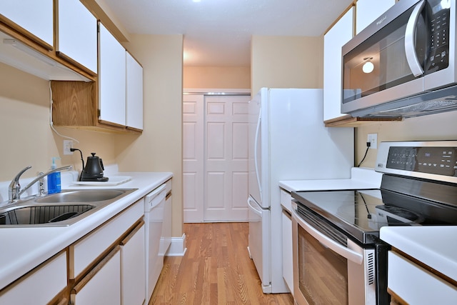 1813 Hemlock Pl Unit 306, Schaumburg, IL 60173 - kitchen featuring appliances with stainless steel finishes, light wood-style flooring, white cabinets, and light countertops