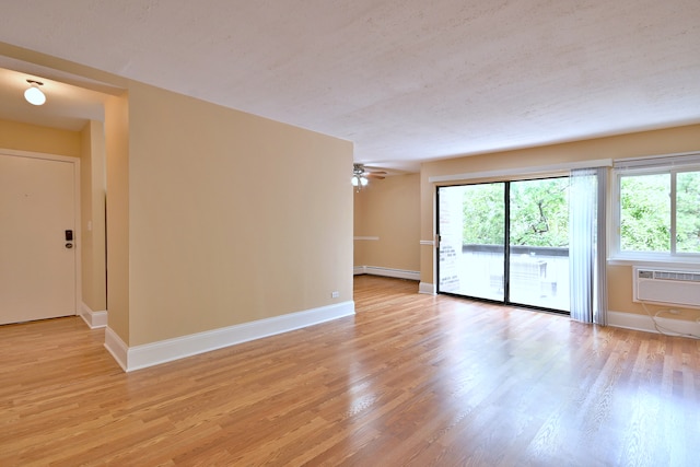 1813 Hemlock Pl Unit 306, Schaumburg, IL 60173 - empty room with light wood-style floors, a wall mounted AC, a baseboard radiator, and ceiling fan