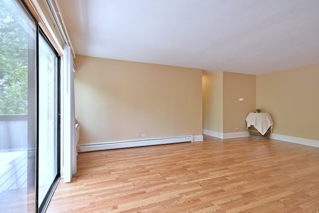 1813 Hemlock Pl Unit 306, Schaumburg, IL 60173 - empty room featuring a baseboard radiator and light wood finished floors