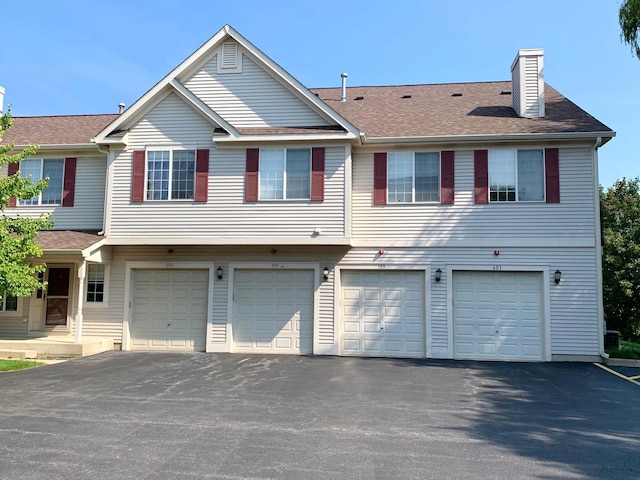 601 Fox Ridge Dr Unit 601, Fox Lake, IL 60020 - view of front of home featuring an attached garage, driveway, and a shingled roof