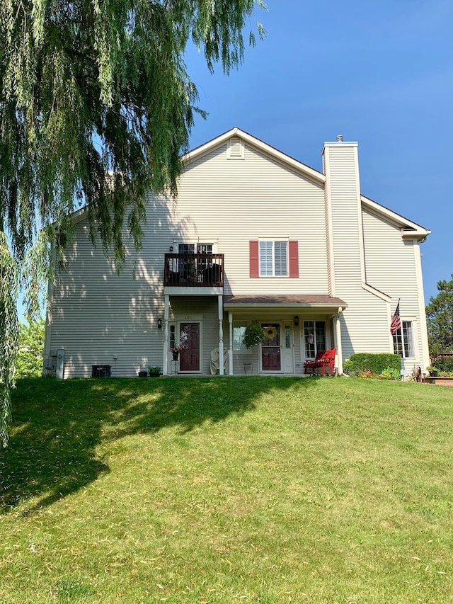601 Fox Ridge Dr Unit 601, Fox Lake, IL 60020 - view of front of house featuring a chimney and a front lawn