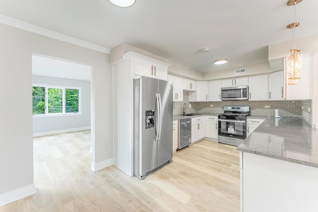 437 Winnebago St, Park Forest, IL 60466 - kitchen featuring appliances with stainless steel finishes, light stone counters, light wood-style floors, and tasteful backsplash