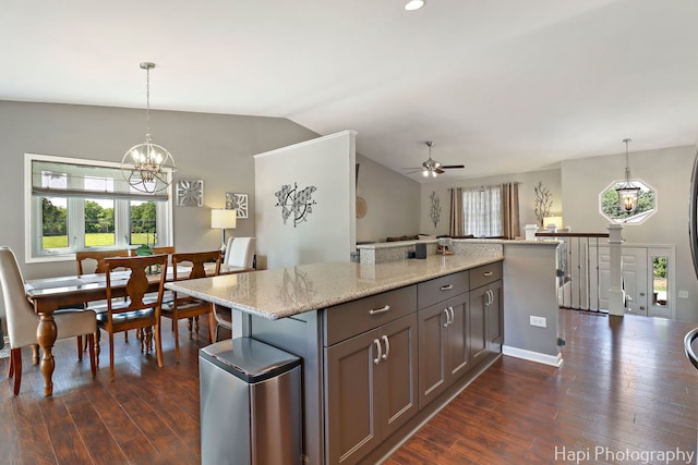 809 W Sheridan Rd, Mchenry, IL 60051 - kitchen with a ceiling fan, dark wood-type flooring, lofted ceiling, a kitchen island, and a chandelier