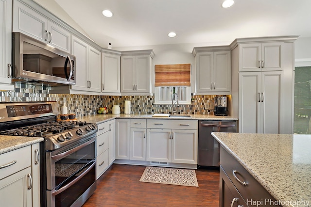 809 W Sheridan Rd, Mchenry, IL 60051 - kitchen featuring stainless steel appliances, tasteful backsplash, dark wood-type flooring, light stone counters, and recessed lighting