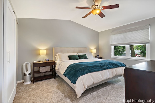 809 W Sheridan Rd, Mchenry, IL 60051 - bedroom featuring vaulted ceiling, light carpet, and a ceiling fan