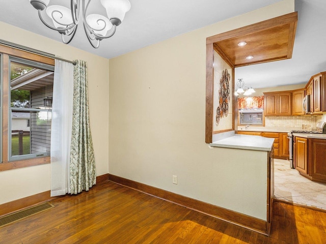 512 S Elida St, Winnebago, IL 61088 - unfurnished dining area with a chandelier and light wood-style floors