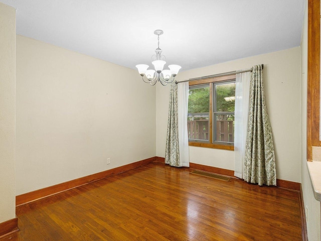512 S Elida St, Winnebago, IL 61088 - empty room featuring a chandelier and wood finished floors