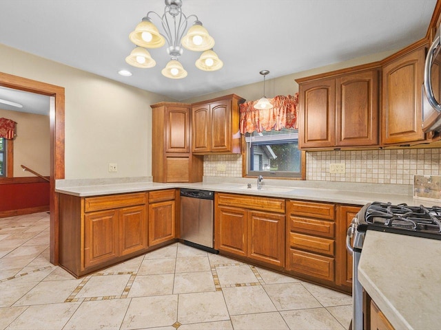 512 S Elida St, Winnebago, IL 61088 - kitchen with appliances with stainless steel finishes, light countertops, decorative backsplash, and brown cabinets
