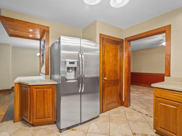 512 S Elida St, Winnebago, IL 61088 - kitchen featuring stainless steel fridge with ice dispenser, brown cabinets, light countertops, light tile patterned floors, and recessed lighting