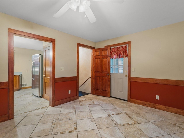512 S Elida St, Winnebago, IL 61088 - unfurnished room featuring ceiling fan and a wainscoted wall