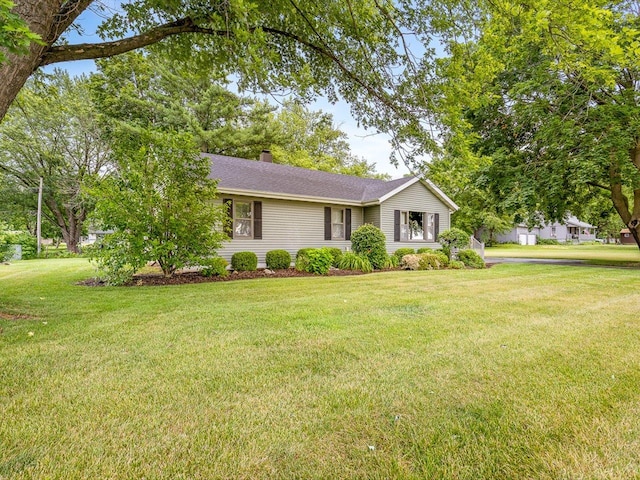 512 S Elida St, Winnebago, IL 61088 - ranch-style house featuring a front lawn, a chimney, and roof with shingles
