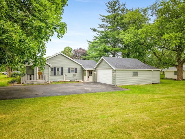 512 S Elida St, Winnebago, IL 61088 - ranch-style home featuring a garage, asphalt driveway, a front lawn, and roof with shingles